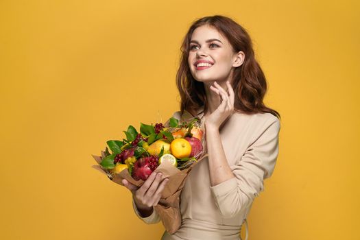 beautiful woman fashionable hairstyle bouquet of flowers decoration yellow background. High quality photo