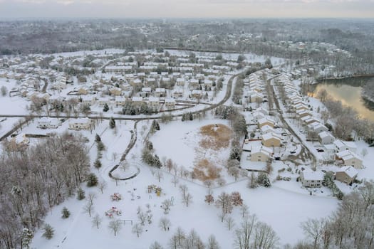 Aerial top view of landscape small town with apartment complex covered in the wonderful winter scenery white snow
