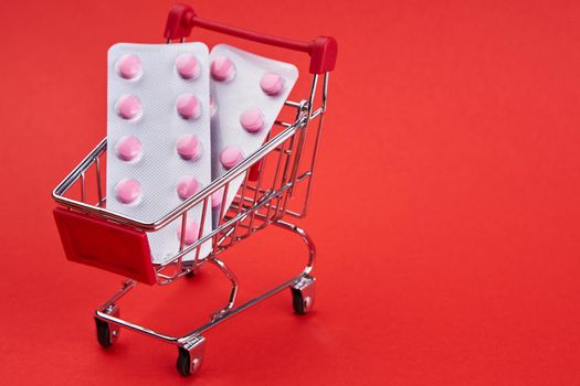 small trolley with medicines pharmacy shop pharmacy pills shopping. High quality photo
