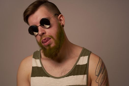 bearded man wearing sunglasses posing emotions isolated background. High quality photo