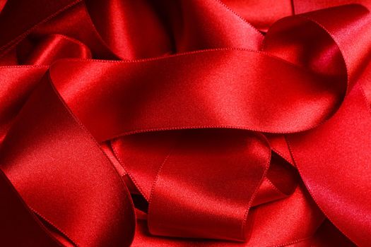 Masses heap of red satin ribbon background Holiday Christmas gift package concept