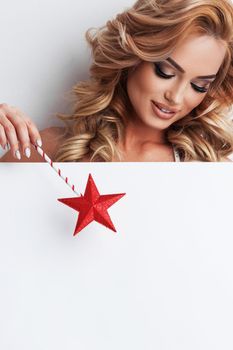 Fairy woman with star magic wand pointing at white banner background with copy space for text