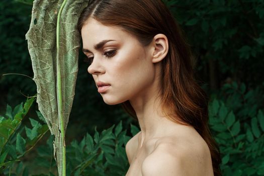 beautiful woman in a field outdoors bare shoulders clear skin cropped view. High quality photo