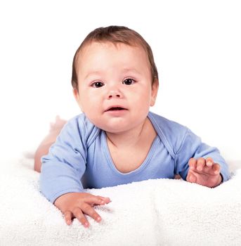 Little baby boy lying on the bed and smiling