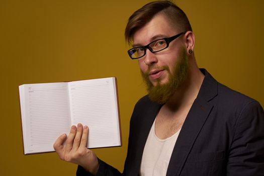 bearded man in a black jacket with a book in his hands education. High quality photo