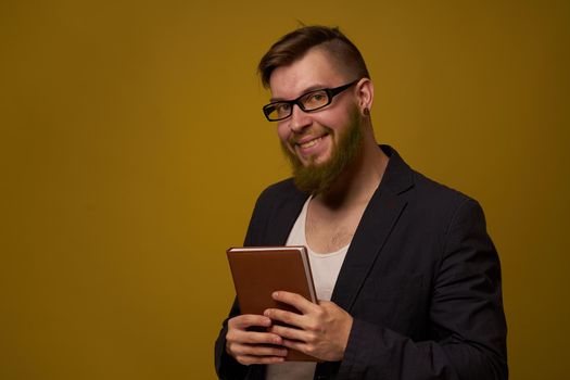 bearded man in a black jacket with a book in his hands education. High quality photo
