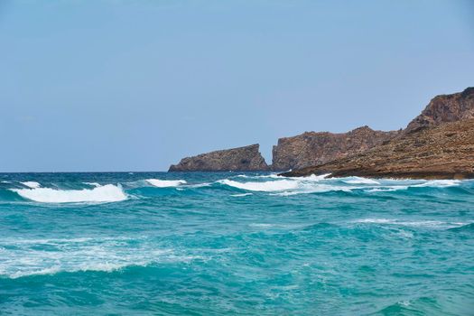 Cliff on the coast in the shape of a letter v. Mediterranean Sea, Balearic Islands, turquoise water, moving water