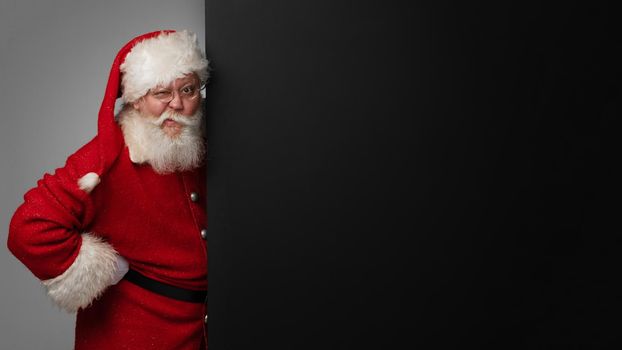 Santa Claus holding black banner with copy space for text
