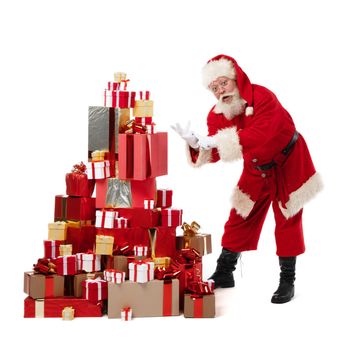 Santa Claus dancing near large pile of Christmas gifts isolated on white background