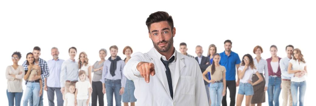 Portrait of friendly therapist doctor pointing at you and looking at camera with smile crowd many casual people on background, isolated on white