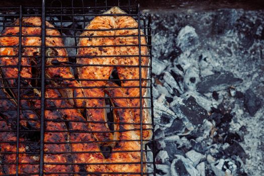 cooking fish outdoors barbecue close-up charcoal meal. High quality photo