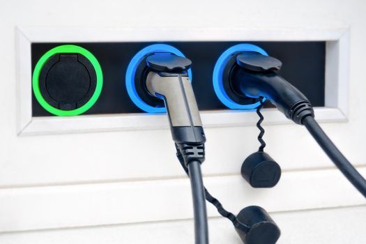 EV charging point for three electric cars parking service. Electric car charger connector for charging electric vehicle socket parking EV charger car recharge battery electric vehicle charging station