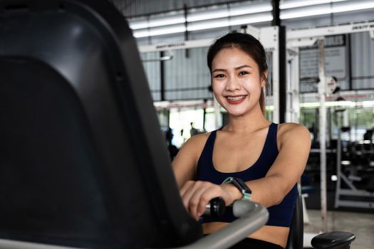 A portrait of asian young girl or woman doing cardio workout in a gym