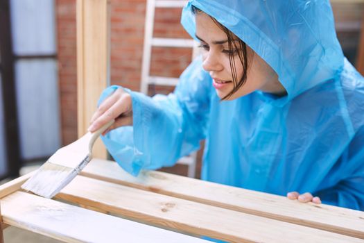 woman painter in protective clothing renovation design house. High quality photo