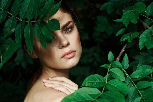portrait of a woman green leaves clean skin nature summer close-up. High quality photo