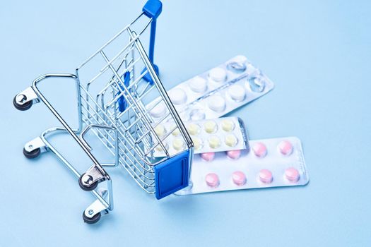 pill cart shopping medicine pharmacy blue background. High quality photo