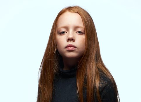 red-haired girl in a black sweater planning close-up. High quality photo