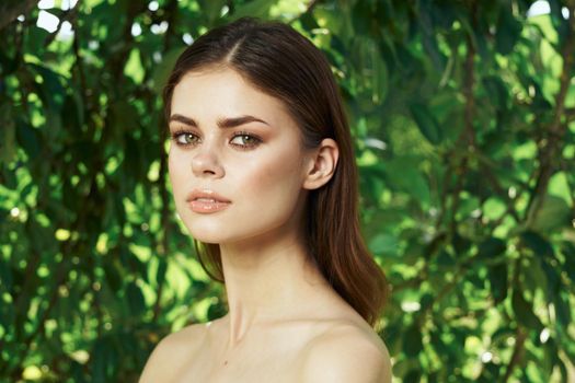 portrait of a woman green leaves clean skin nature summer close-up. High quality photo