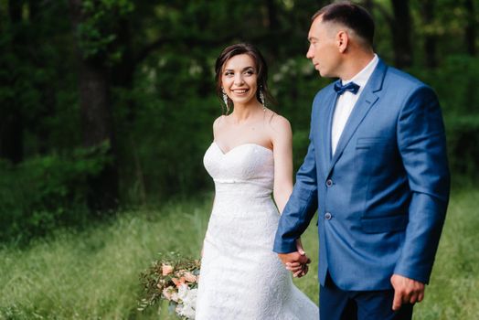 A couple in love a guy and a girl on a walk in the forest belt