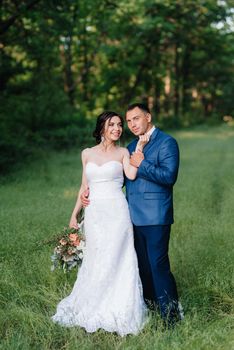 A couple in love a guy and a girl on a walk in the forest belt