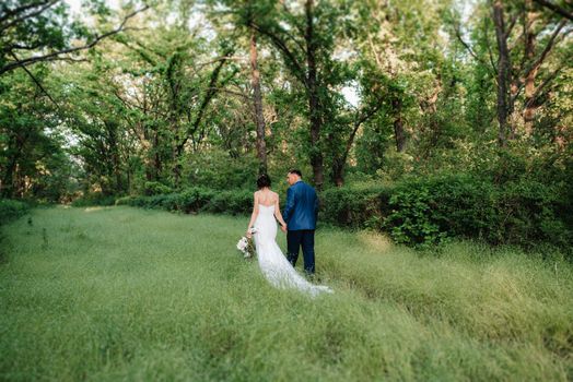 A couple in love a guy and a girl on a walk in the forest belt