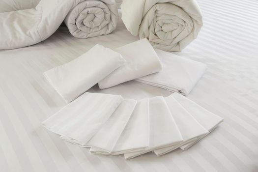 White pillowcase on white bed