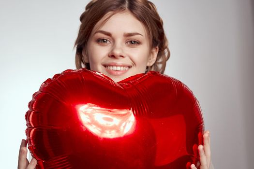 cheerful woman in a dress balloon Valentine's Day model studio. High quality photo