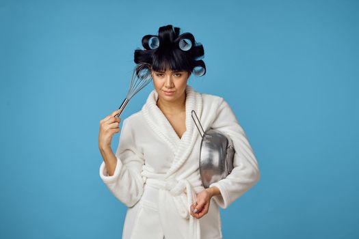 housewife in white coat housework cleaning blue background. High quality photo