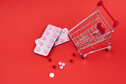 small trolley with medicines pharmacy shop pharmacy pills shopping. High quality photo