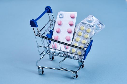 packs of pills in a trolley shopping in a pharmacy medicines. High quality photo