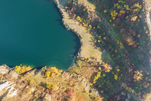 Artificial lake in a quarry with turquoise background of the clearwater autumn season in aerial view