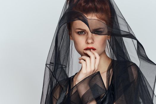 woman with black veil dress posing elegant style. High quality photo