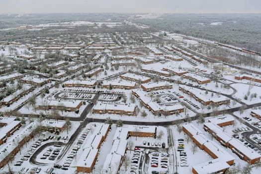 Aerial top view of winter landscape American town small apartment complex a snowy winter on streets after snowfall