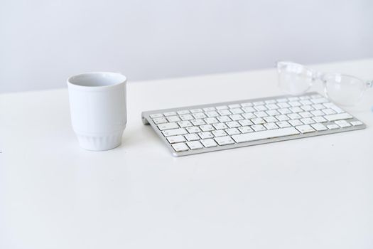 wireless keyboard on desktop cup documents office. High quality photo