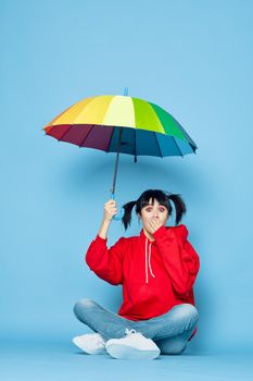 cheerful woman in red t-shirt rainbow color umbrella fashion. High quality photo