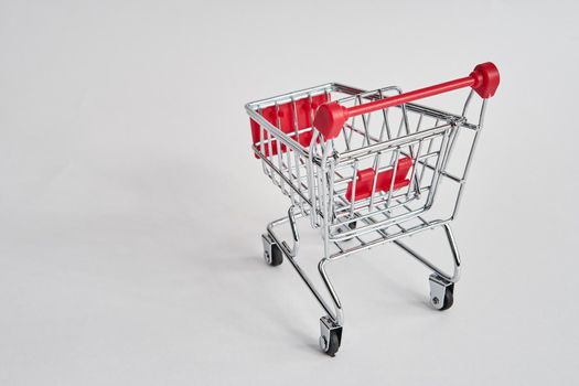 empty trolley on light background shopping supermarket service. High quality photo