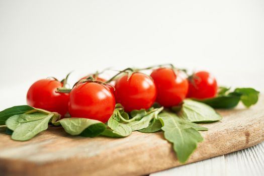 cherry tomatoes lettuce leaves wooden board fresh food. High quality photo