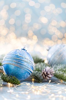 Christmas spruce with ball and blurred shiny lights.