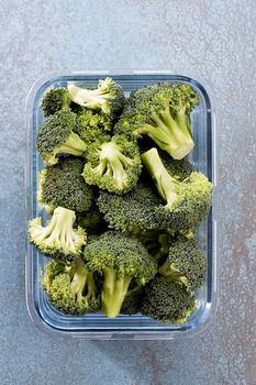 Washed And Sliced Broccoli Crown In Glass Container.
Organic broccoli, cut up and ready to be used in cooking.