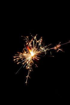 Christmas sparkler lights on black background. 