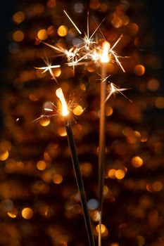 Christmas sparkler lights on black background.