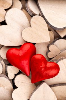 Wooden hearts pattern, one red heart on the wooden heart background.	

