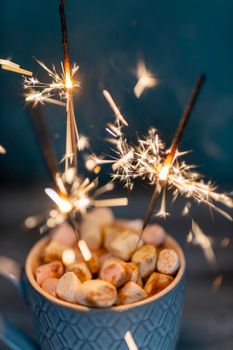 Christmas sparkler lights on black background.