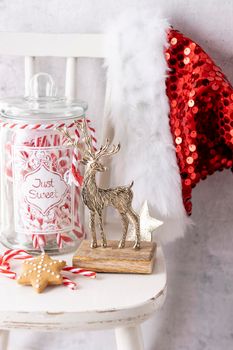 Christmas Santa Claus Hat Hanging On Wood chair, Xmas Concept, Decoration Over Grunge Wooden Background.