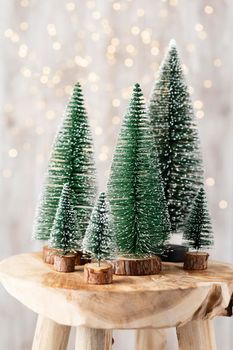 Christmas tree on wooden, bokeh background. Christmas holiday celebration concept. Greeting card.