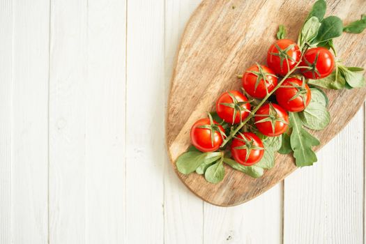 cherry tomatoes lettuce leaves wooden board fresh food. High quality photo