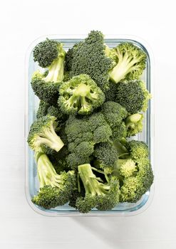 Washed And Sliced Broccoli Crown In Glass Container.
Organic broccoli, cut up and ready to be used in cooking.