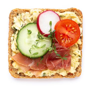 Variety of mini sandwiches with cream cheese, vegetables and salami. Sandwiches with cucumber, radish, tomatoes, salami on a white background, top view. Flat lay.