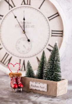 New Year's clock. Decorated with christmas tree decorations background. Celebration Concept for New Year Eve.