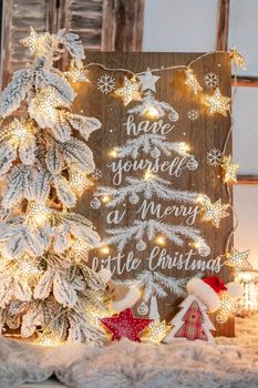 Board with Merry Christmas message on wooden background.